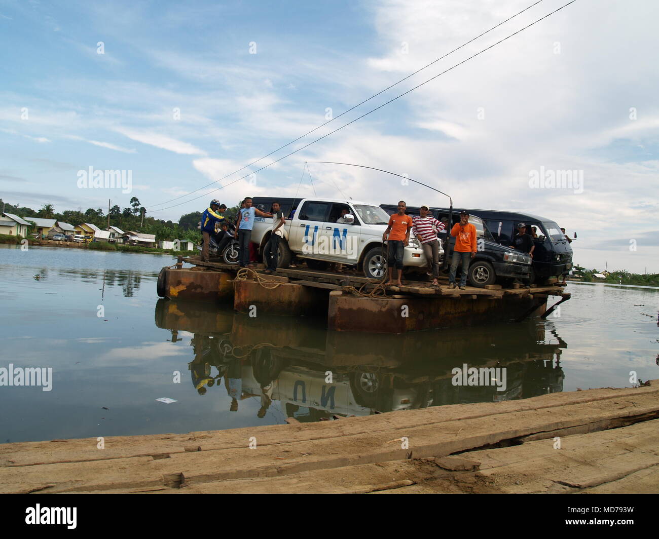 United Nations Vehicle loaded on a raft to crossing over the water bay ...