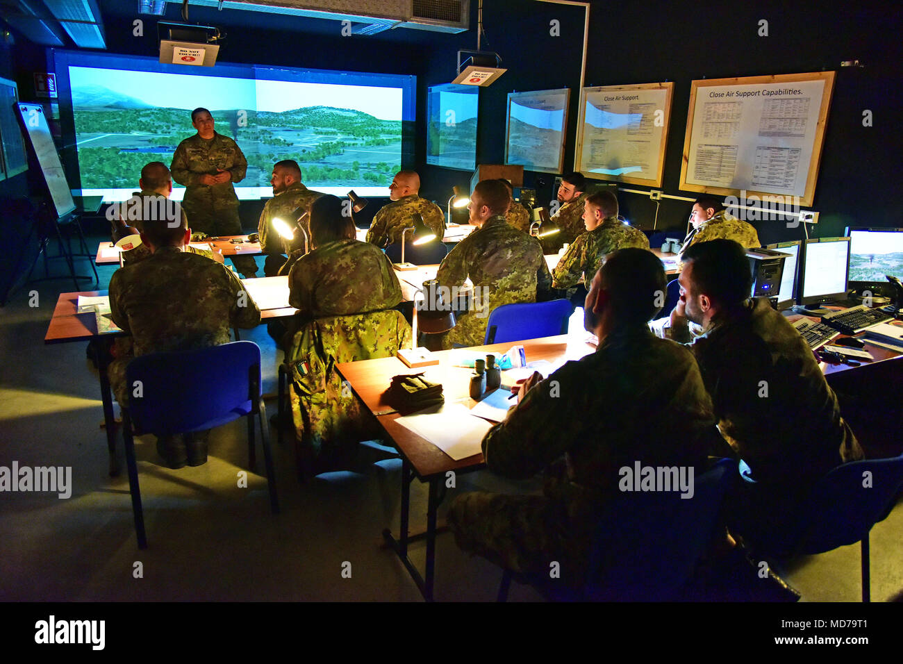U.S. Army Staff Sgt. Change L. McGraw, a Paratrooper assigned to the 173rd Airborne Brigade instructs Italian Army Paratroopers assigned to Regiment “Savoia Cavalleria” Folgore Brigade Grosseto, during training using Call For Fire Trainer system (CFFT) at Caserma Ederle Vicenza, Italy, March 27, 2018. Italian Paratroopers use U.S. Army RTSD South equipment to enhance bilateral relations and to expand levels of cooperation and the capacity of the personnel involved in joint operations. (U.S. Army photo by Paolo Bovo) Stock Photo