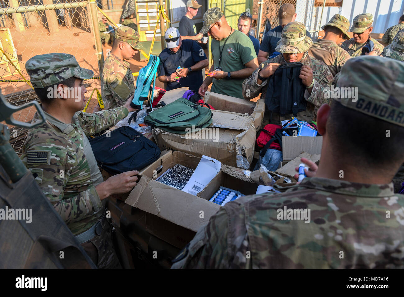 U.S. Army Soldiers with Animal Company, 3rd Battalion, 141st Infantry Regiment, assigned to Combined Joint Task Force - Horn of Africa (CJTF-HOA) put school supplies into backpacks to be given to Somali children in Ali Oune, Djibouti, March 28, 2018. CJTF-HOA service members donated more than $400 of school supplies and sandals to Somali refugees in Djibouti. (U.S. Air Force photo by Staff Sgt. Timothy Moore) Stock Photo