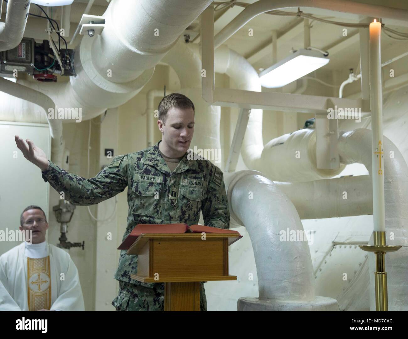 180401-N-GR168-0005 MEDITERRANEAN SEA (April 1, 2018) Lt. Blake Pauley, from Hudson, Ohio, reads scripture during Easter mass in the chapel aboard the San Antonio-class amphibious transport dock ship USS New York (LPD 21) April 1, 2018. New York, homeported in Mayport, Fla., is conducting naval operations in the U.S. 6th Fleet area of operations. (U.S. Navy photo by Mass Communication Specialist 2nd Class Lyle Wilkie/Released) Stock Photo