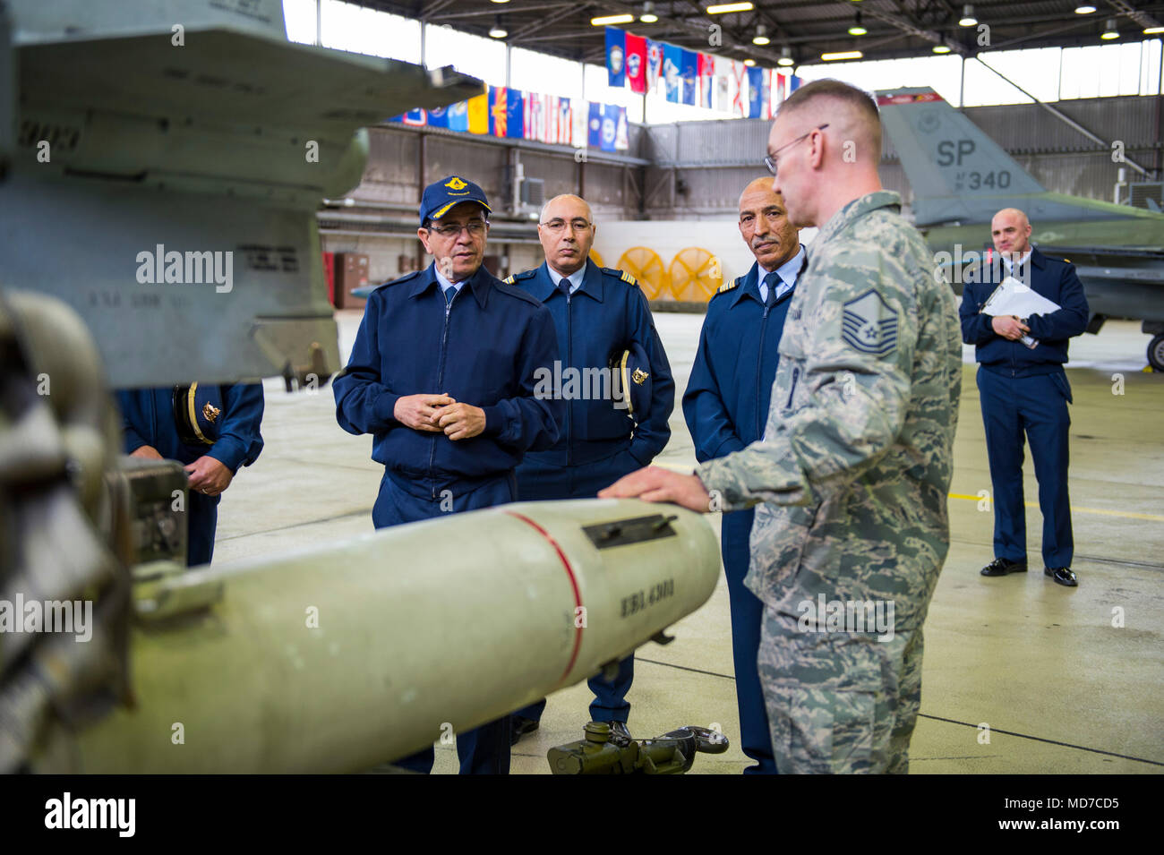 Maj. Gen. Hassan Fakri, Royal Moroccan Air Force deputy inspector, is given a tour by Master Sgt. Jason Tremmel, 52nd Maintenance Group load standardization crew team chief, of the various dummy weapons at Spangdahlem Air Base, Germany, March 28, 2018. Senior leaders from the RMAF spent time learning about the best practices of the 52nd MXG, Operations Group and the 480th Fighter Squadron. (U.S. Air Force photo by Senior Airman Dawn M. Weber) Stock Photo