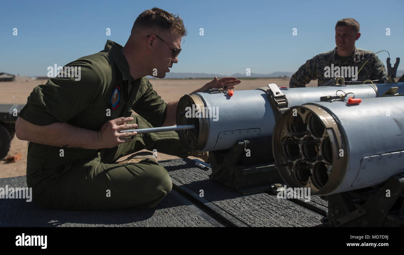 U.S. Marine Cpl. Zackery Johnson, a Marine Aviation Logistics Squadron 26 aviation ordnance system technician, loads a 2.75-inch rocket configured with Advanced Precision Kill Weapon System II, a hydra 70 rocket motor and M282 High Explosive Incendiary Multipurpose Penetrator Warhead into an LAU-68 F/A rocket launcher during ordnance building and preparation in support of Weapons and Tactics Instructor course 2-18 at Marine Corps Air Station Yuma, Ariz., March 28. WTI is a seven-week training event hosted by MAWTS-1 cadre, which emphasizes operational integration of the six functions of Marine Stock Photo