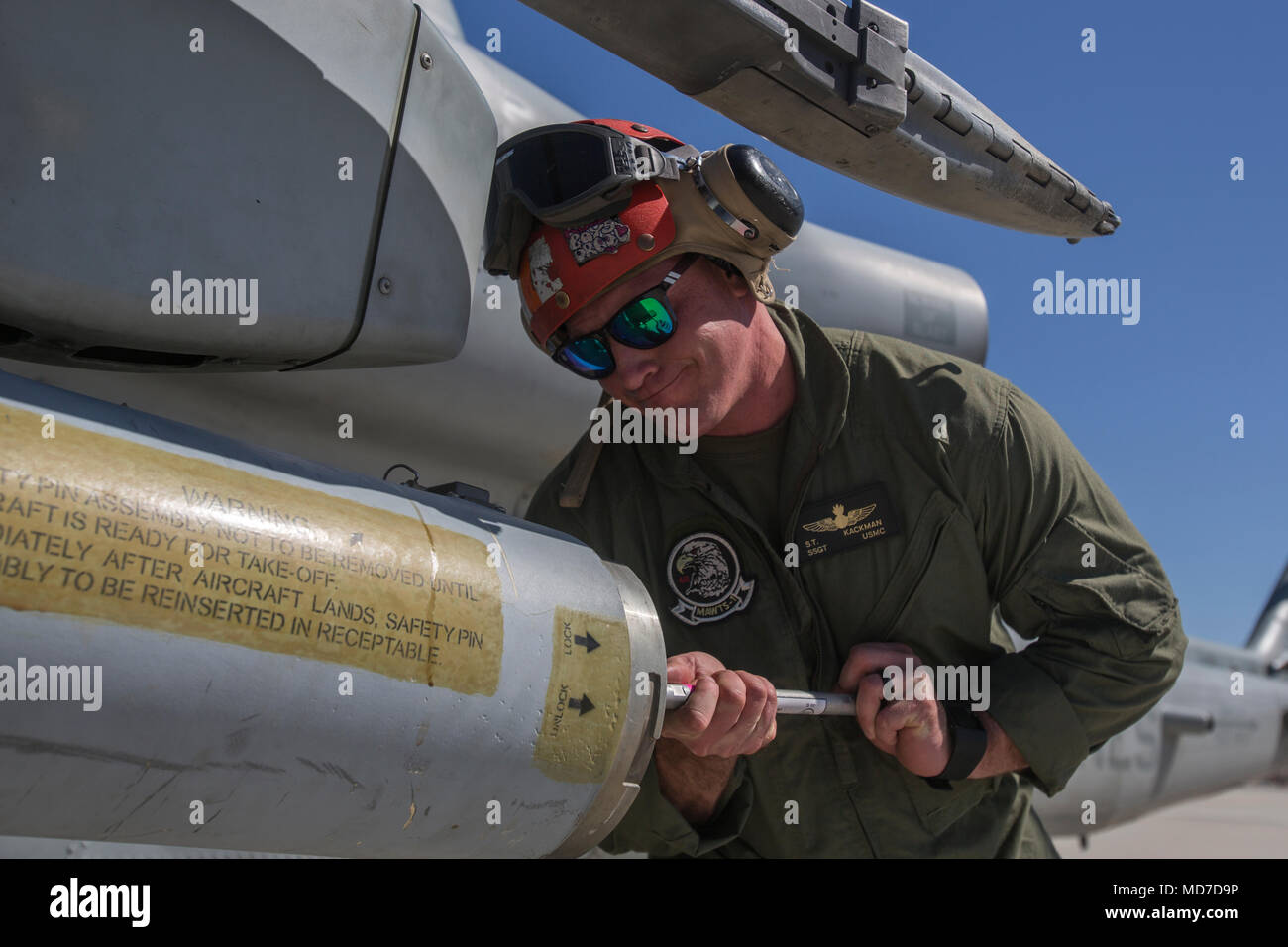 U.S. Marine Corps Staff Sgt. Samuel Kackman, a Marine Aviation Weapons and Tactics Squadron 1 aircraft ordnance technician, secures a 2.75-inch rocket configured with Advanced Precision Kill Weapon System II, a hydra 70 rocket motor and M282 High Explosive Incendiary Multipurpose Penetrator Warhead during a APKWS loading and flight takeoff exercise in support of Weapons and Tactics Instructor course 2-18 at Marine Corps Air Station Yuma, Ariz., March 29. WTI is a seven-week training event hosted by MAWTS-1 cadre, which emphasizes operational integration of the six functions of Marine Corps avi Stock Photo