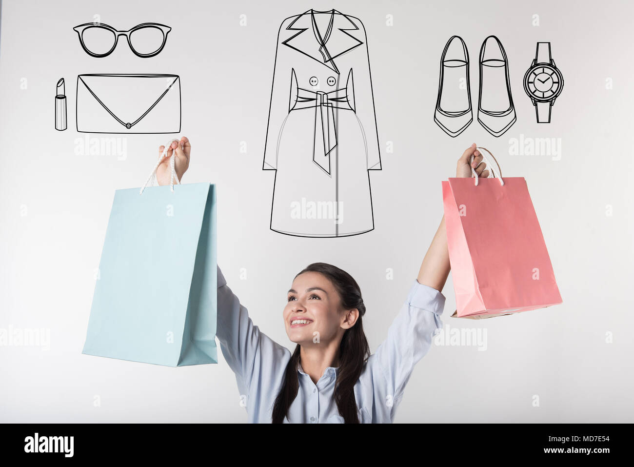 Excited student putting her hands up while doing shopping Stock Photo