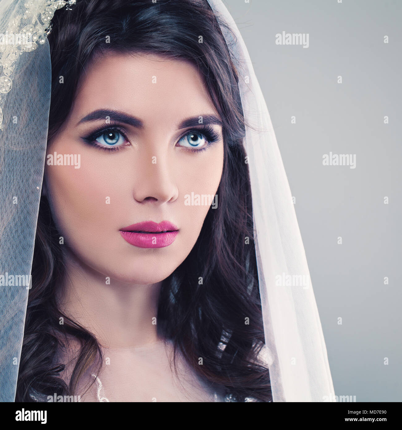 Nice Bride. Beautiful Young Woman Fiancee with Permed Hair, Makeup and Veil Stock Photo