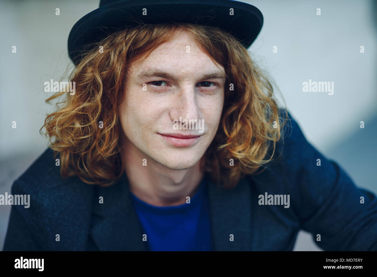Fashion Portrait Of Young Reddish Man With Long Curly Hair