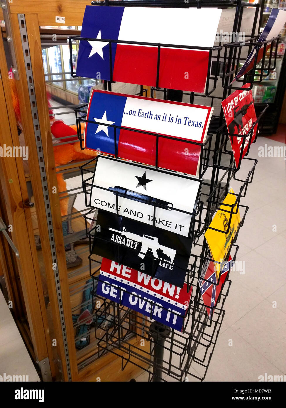 In a small town of Oklaunion, Texas, the convenience store along US 287 offers everything from gas, fried chicken, milk and bumper stickers. Bumper stickers that express their rural view on America and pride in being a Texan. Stock Photo