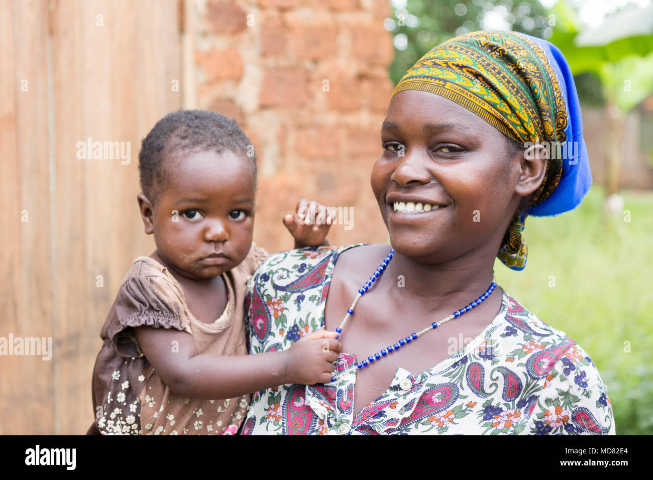 Uganda. June 09 2017. A happy and smiling young African woman holding her child in her arms. Stock Photo