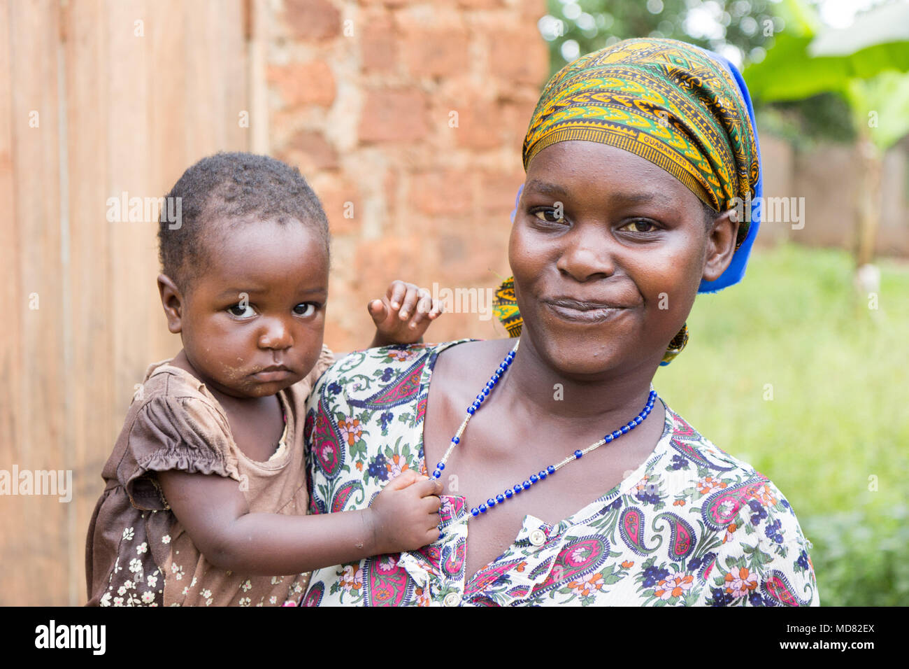 Uganda. June 09 2017. A happy and smiling young African woman holding her child in her arms. Stock Photo