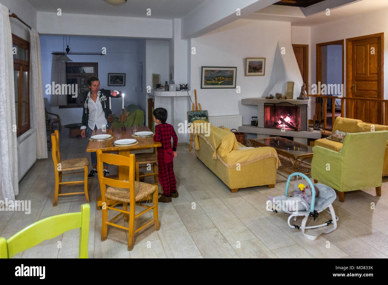 Father and son at the dinner table in their house, Greece Stock Photo