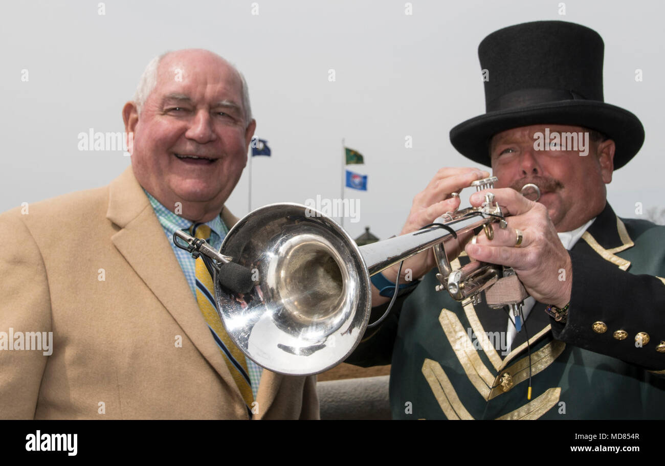 U.S. Secretary of Agriculture Sonny Perdue gets an up-close and personal listening to Keeneland Race Track Bugler Steve Buttleman, playing the &quot;Call to Post,&quot; in Lexington, KY, on April 6, 2018.  This is part of the Third &quot;Back to our Roots&quot; RV tour.  “As always, our ‘Back to our Roots’ RV tour is an opportunity to get out of Washington, D.C. to hear directly from the American people in the agriculture community,” Secretary Perdue said. “While Congress continues its work on the Farm Bill, rural prosperity, and many other agriculture priorities, USDA stands ready to assist i Stock Photo