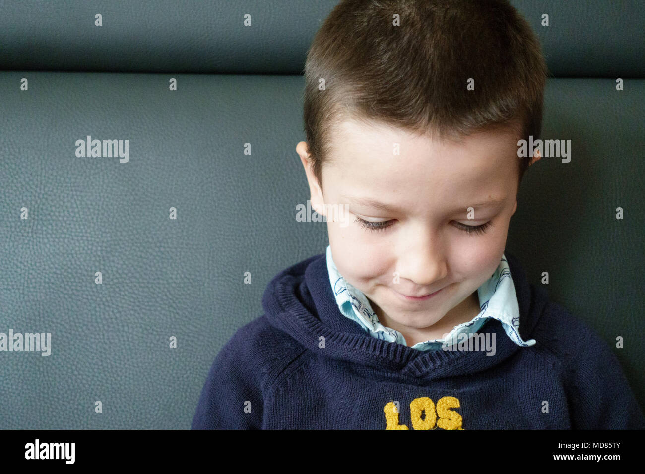 Close-up of boy sitting on couch Stock Photo