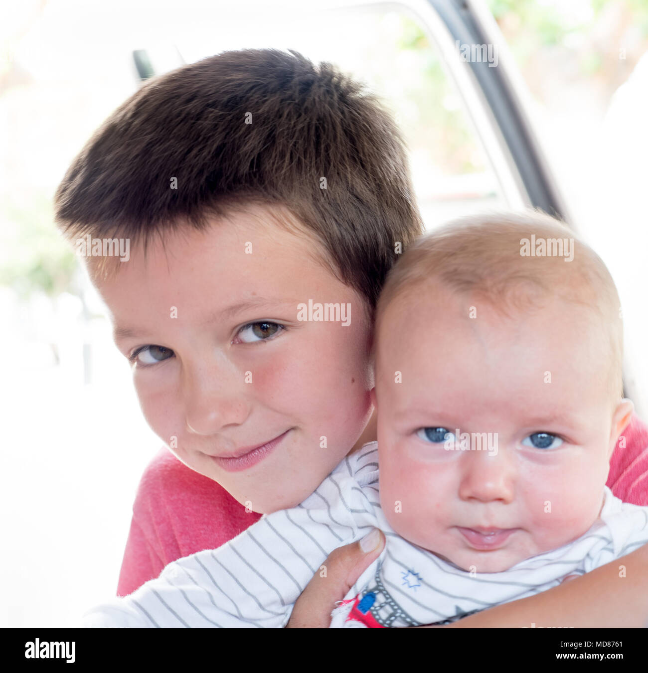 Portrait of boy holding his little baby brother Stock Photo