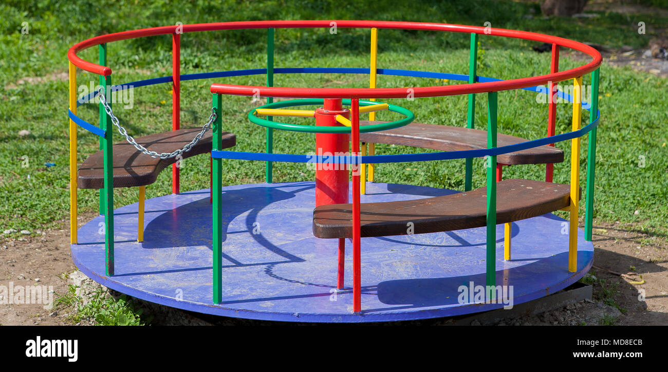 Children's iron carousel. Children's playground. Swing, carousel and ...