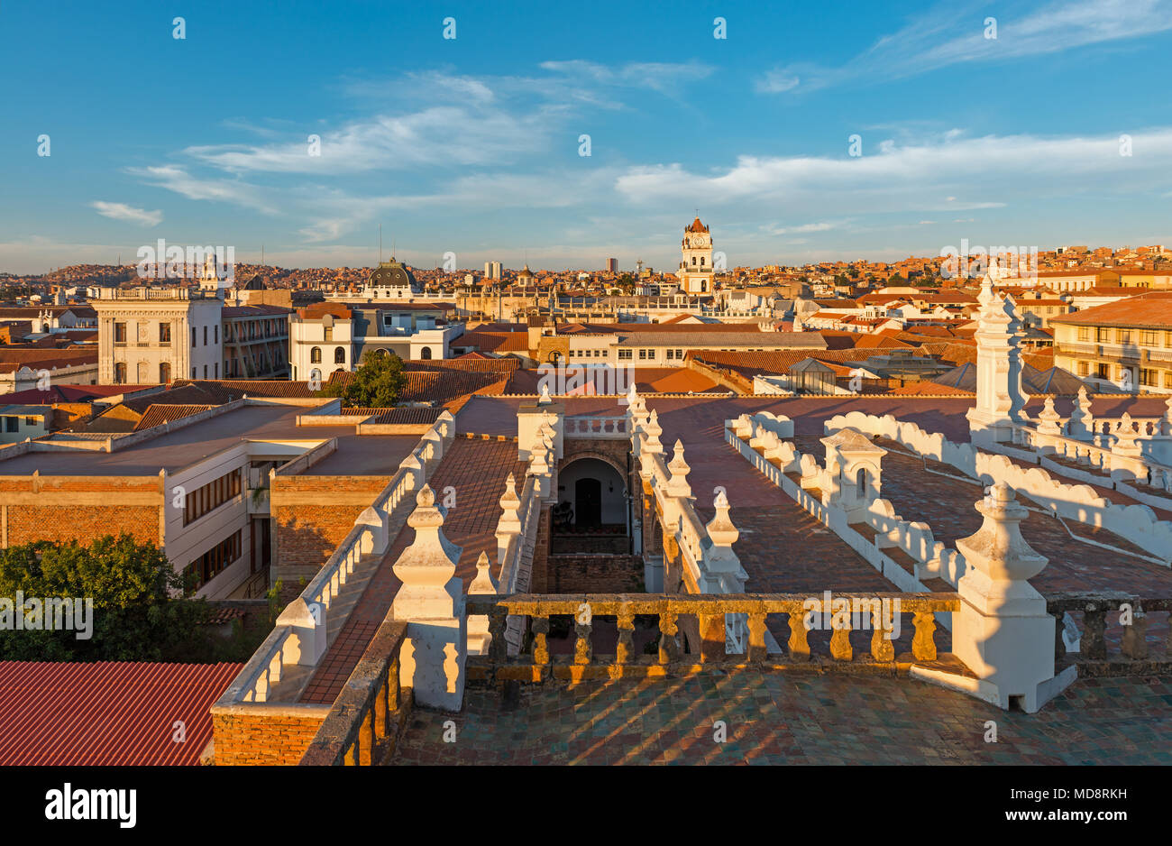 Cityscape and skyline of Sucre city at sunset seen from the roof of the Felipe Neri church in the Andes mountain range, Bolivia, South America. Stock Photo