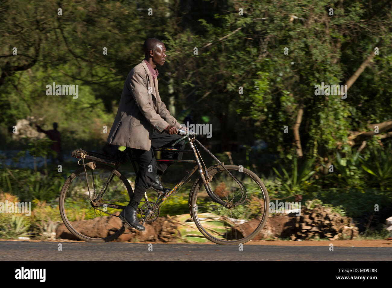 A cyclist rides a traditional roadster style bicycle commonly