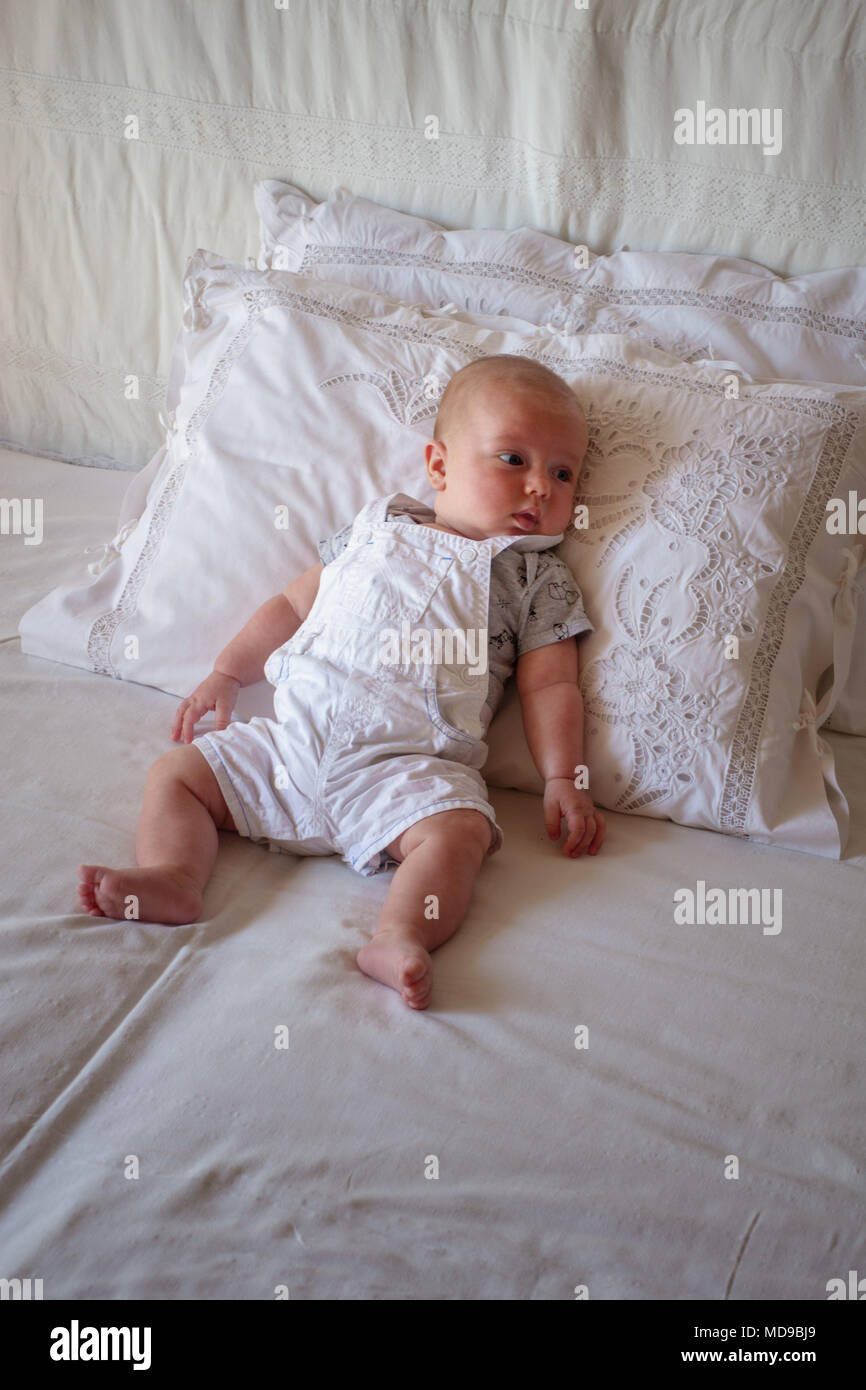 Cute little baby boy lying on bed Stock Photo