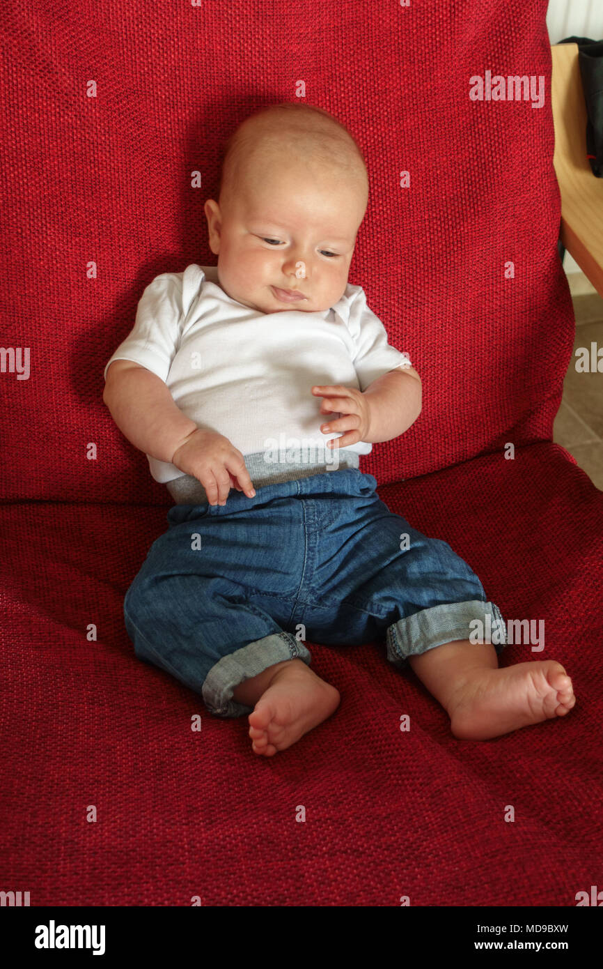 Cute little baby boy lying on armchair Stock Photo Alamy