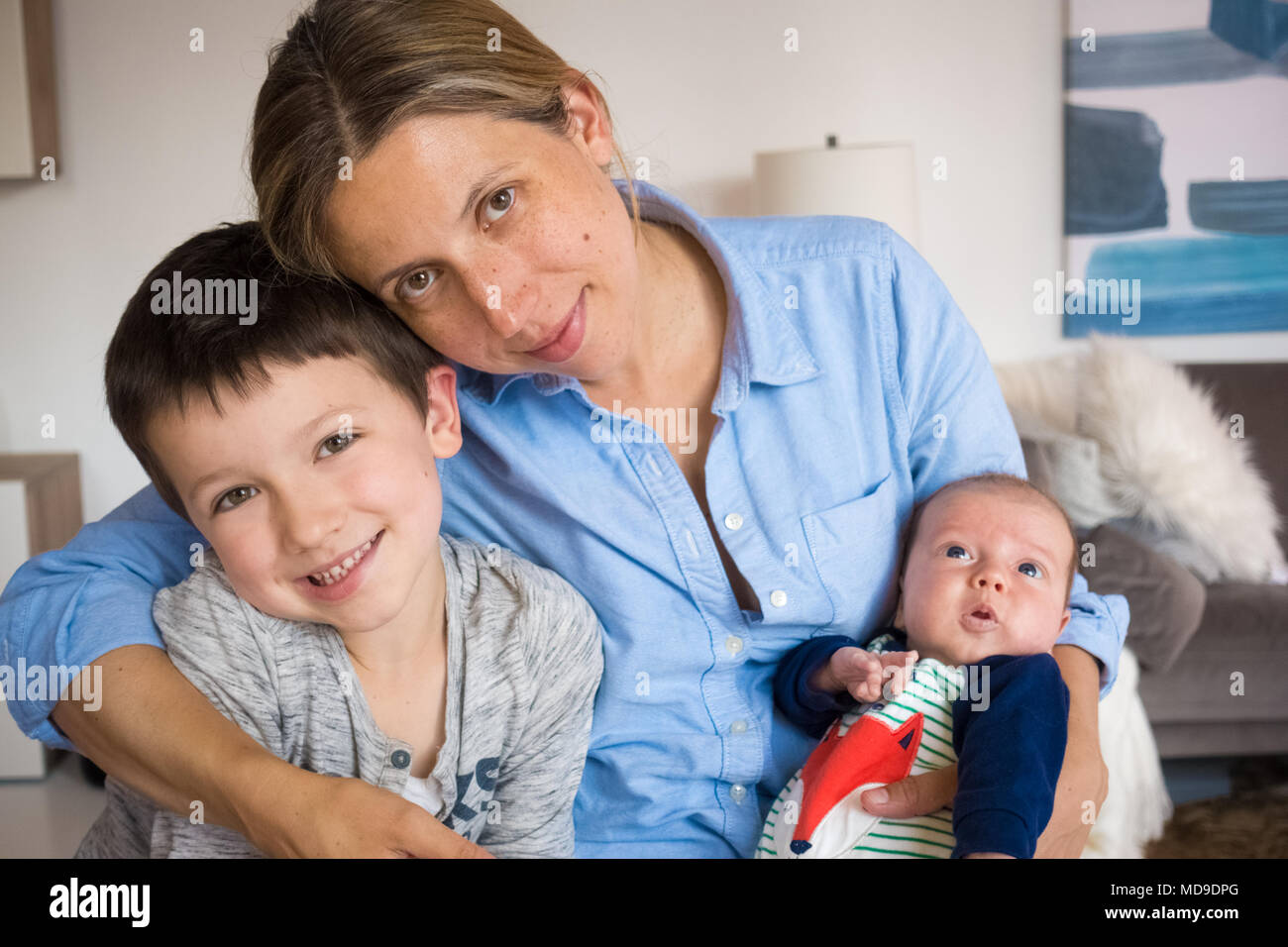 Portrait of mother with two children at home Stock Photo