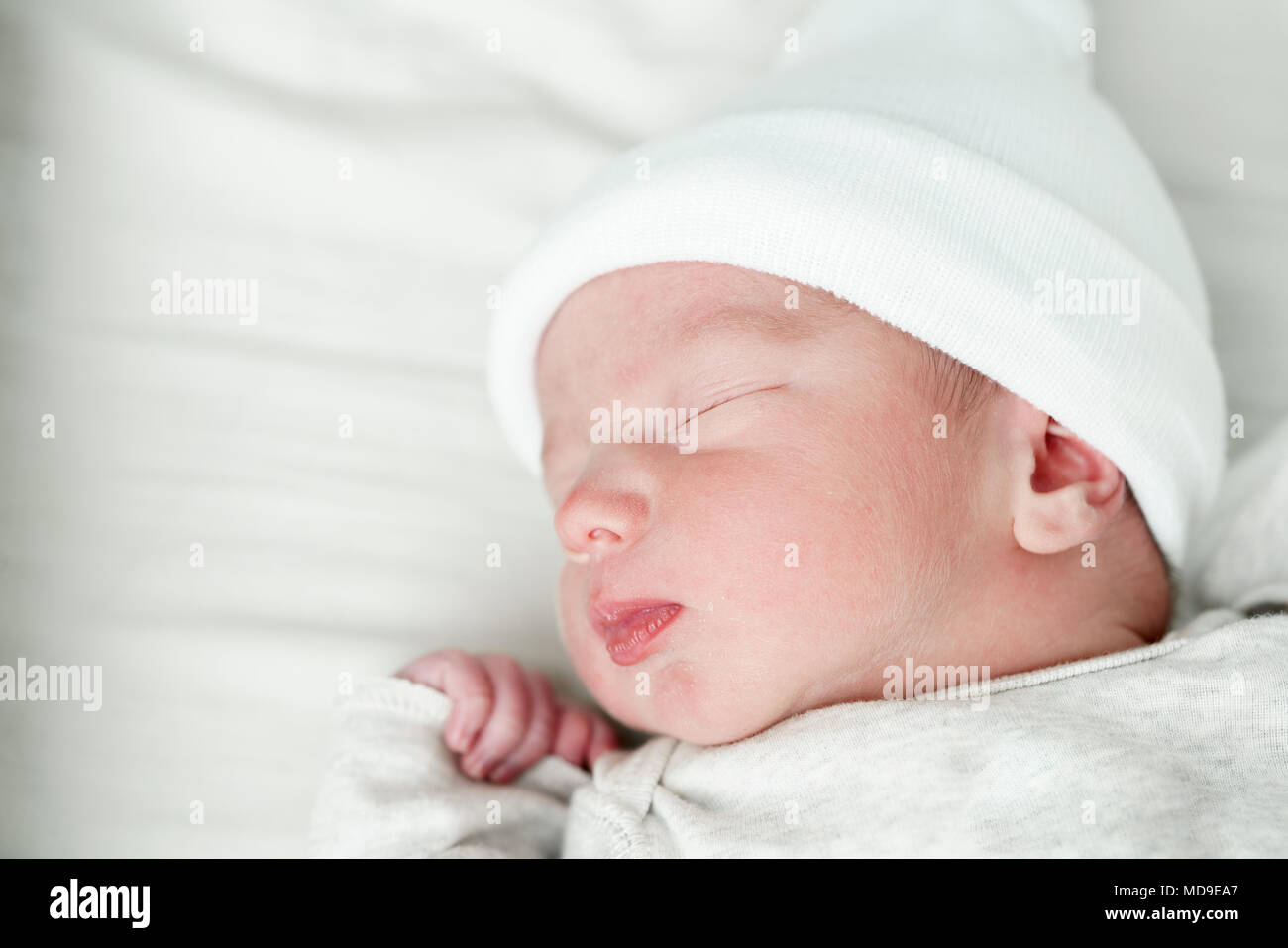 Cute newborn baby boy sleeping on bed Stock Photo