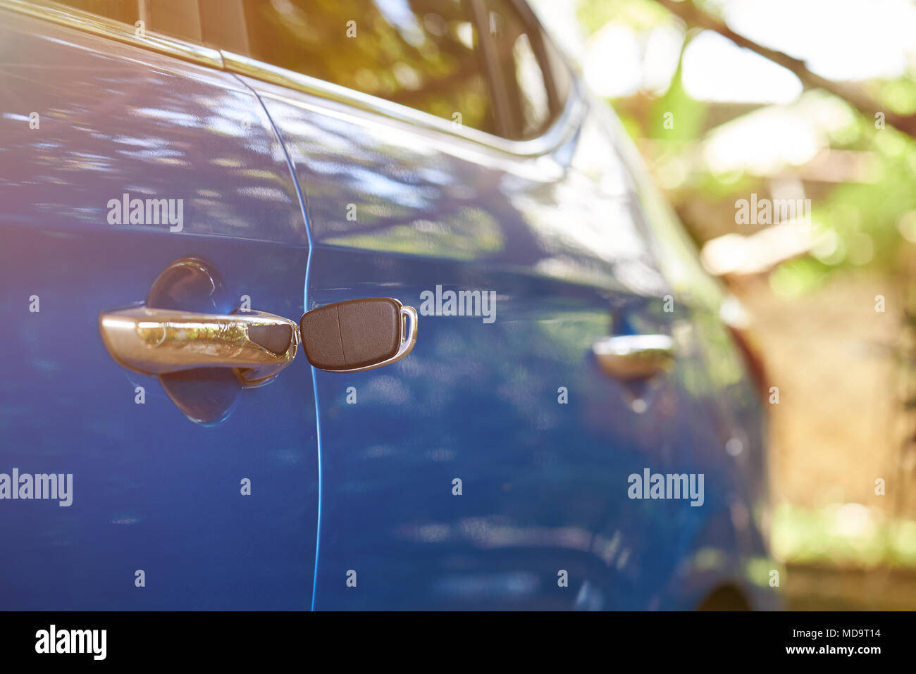 Unlocking vehicle door theme. Key left in car lock Stock Photo
