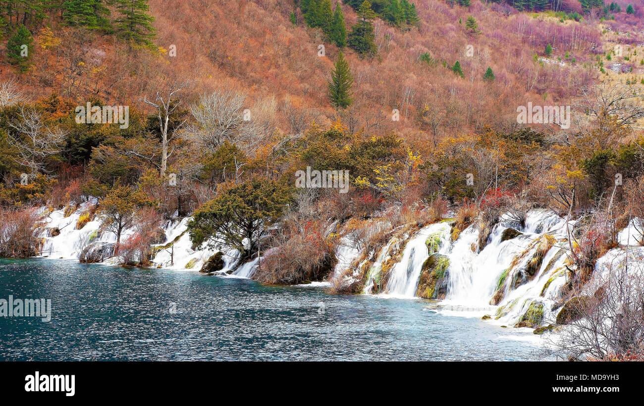 Beautiful Waterfall And Azure Lake With Crystal Clear Water Among Fall