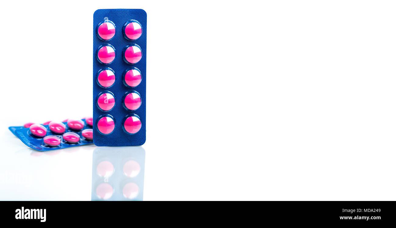 Ibuprofen in pink tablet pills pack in blue blister pack isolated on