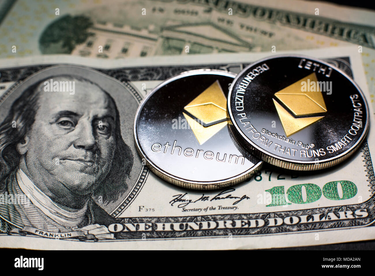 Ethereum coins on top of fiat money Stock Photo - Alamy