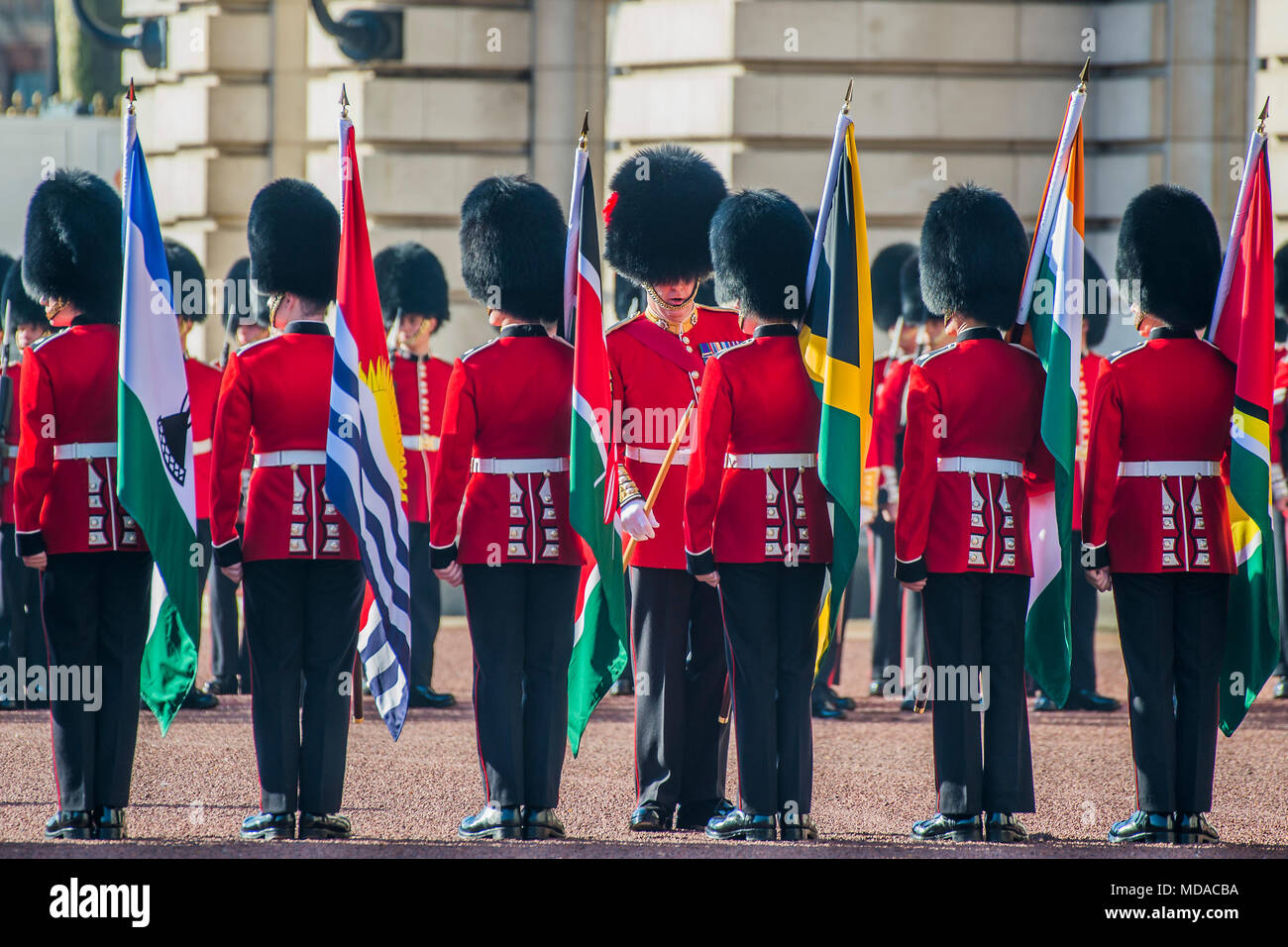 Buckingham Palace, London, UK. 19th Apr, 2018. Inspection - A Guard of Honour, comprised of 104 Officers and soldiers of the Coldstream Guards, accompanied by 55 Flag Bearers of Number 7 Company, Coldstream Guards and the Band and Corps of Drums of the Coldstream Guards at Buckingham Palace. Her Majesty The Queen welcomes the Commonwealth Heads of Government to Buckingham Palace for the formal opening of the summit. Credit: Guy Bell/Alamy Live News Stock Photo