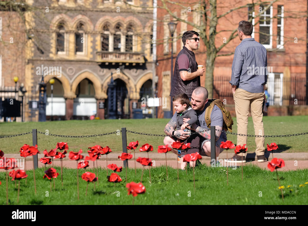 Hereford, Herefordshire - UK Weather - Thursday 19th April 2018  - Hot sunny Spring sunshine in Hereford with local temperatures up to a warm 23c - visitors enjoy the Weeping Window ceramic poppy display at Hereford cathedral which commemorates WW1 1914-1918. The Weeping Window display at Hereford cathedral finishes on April 29th - Photo Steven May / Alamy Live News Stock Photo
