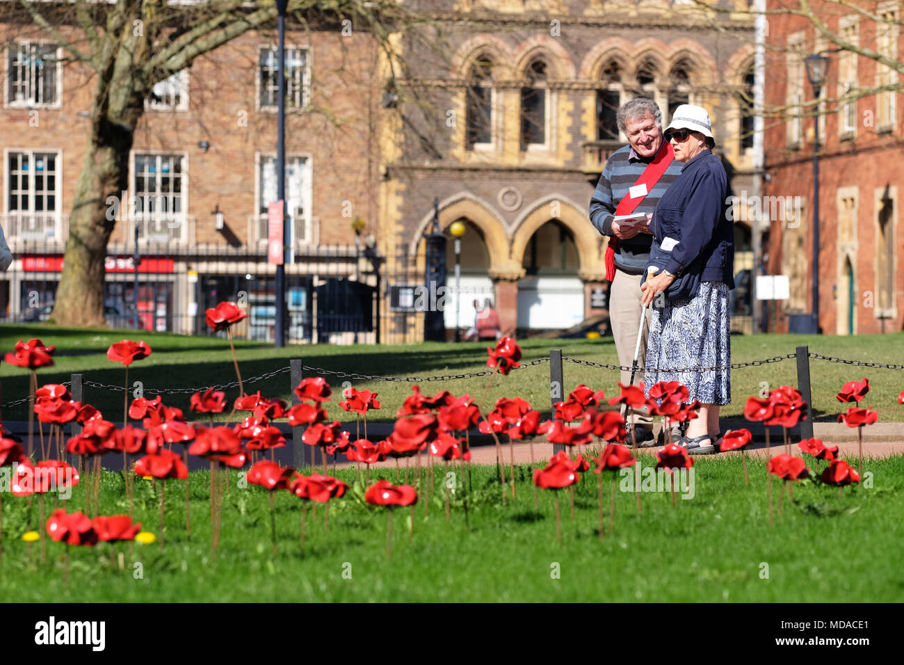 Hereford, Herefordshire - UK Weather - Thursday 19th April 2018  - Hot sunny Spring sunshine in Hereford with local temperatures up to a warm 23c - visitors enjoy the Weeping Window ceramic poppy display at Hereford cathedral which commemorates WW1 1914-1918. The Weeping Window display at Hereford cathedral finishes on April 29th - Photo Steven May / Alamy Live News Stock Photo