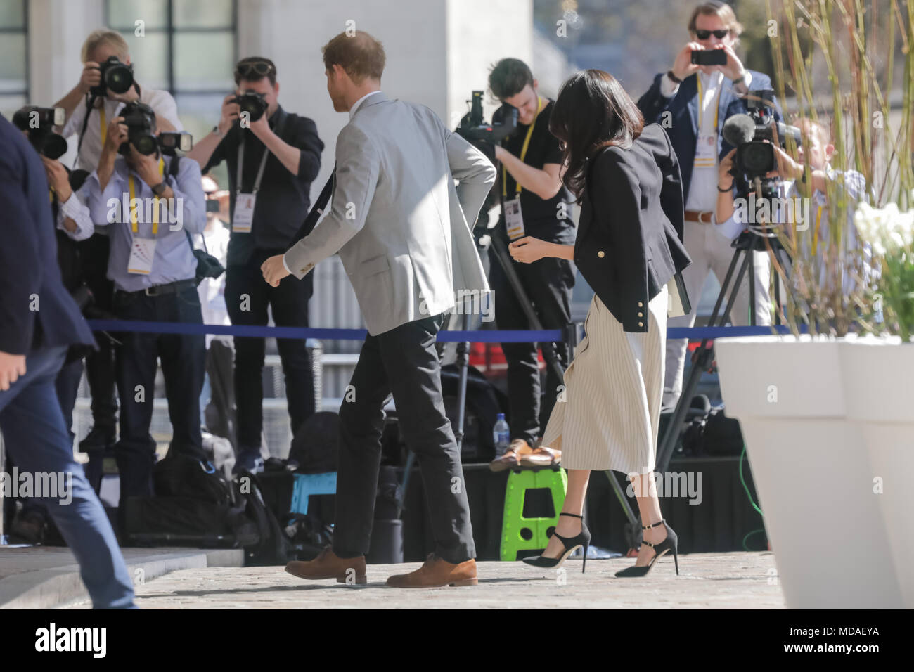 London, UK . 18th April 2018. HRH Prince Harry and Ms. Meghan Markle mirror each others steps perfectly as they walk in unison to a reception with delegates from the Commonwealth Youth Forum at Queen Elizabeth II Conference Centre, London, UK. Credit: Chris Aubrey/Alamy Live News Stock Photo