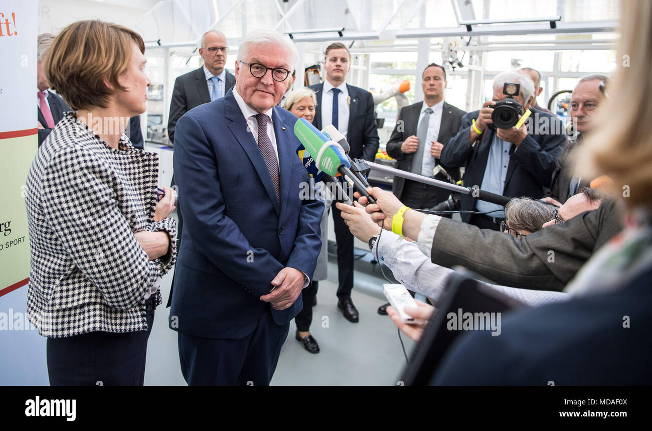 19 April 2018, Germany, Bietigheim-Bissingen: German President Frank-Walter Steinmeier (2.f.l) and his wife Elke Buedenbender (l) give a press conference during a visit to the Lernfabrik 4.0 at the Berufliches Schulzentrum (vocational school centre). Steinmeier and his wife are visiting three vocational schools and a training company in the German state of in Baden-Wuerttemberg. Photo: Sebastian Gollnow/dpa Stock Photo