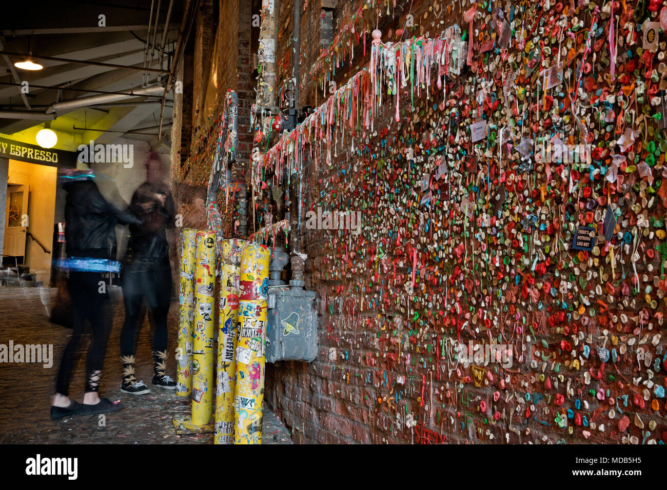 WA15282-00...WASHINGTON - Visitors placing gum on the recently cleaned gum wall in Seattle's Post Alley, located just south of the Pike Place Market. Stock Photo