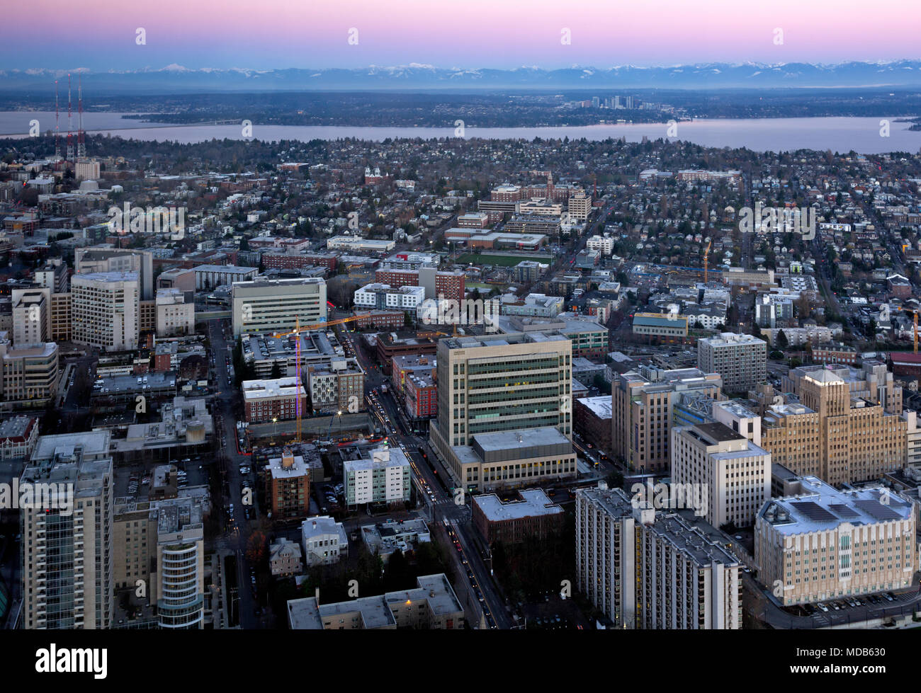 WASHINGTON - View to the east and north at dusk over Capitol Hill, Lake Washington, Bellevue and the Cascade Mountains from the Columbia Center. 2012 Stock Photo