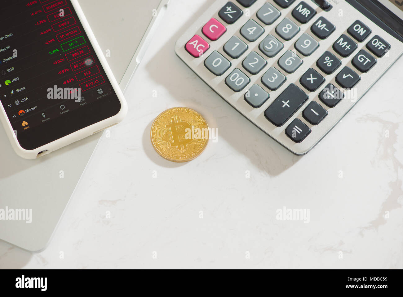 Bitcoin on top of calculator Stock Photo - Alamy