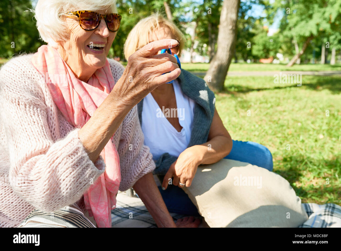 Senior Woman Playing with Fidget Spinner Stock Photo