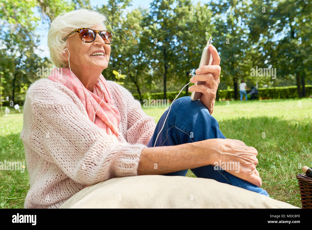 Senior Woman with Smartphone Outdoors Stock Photo