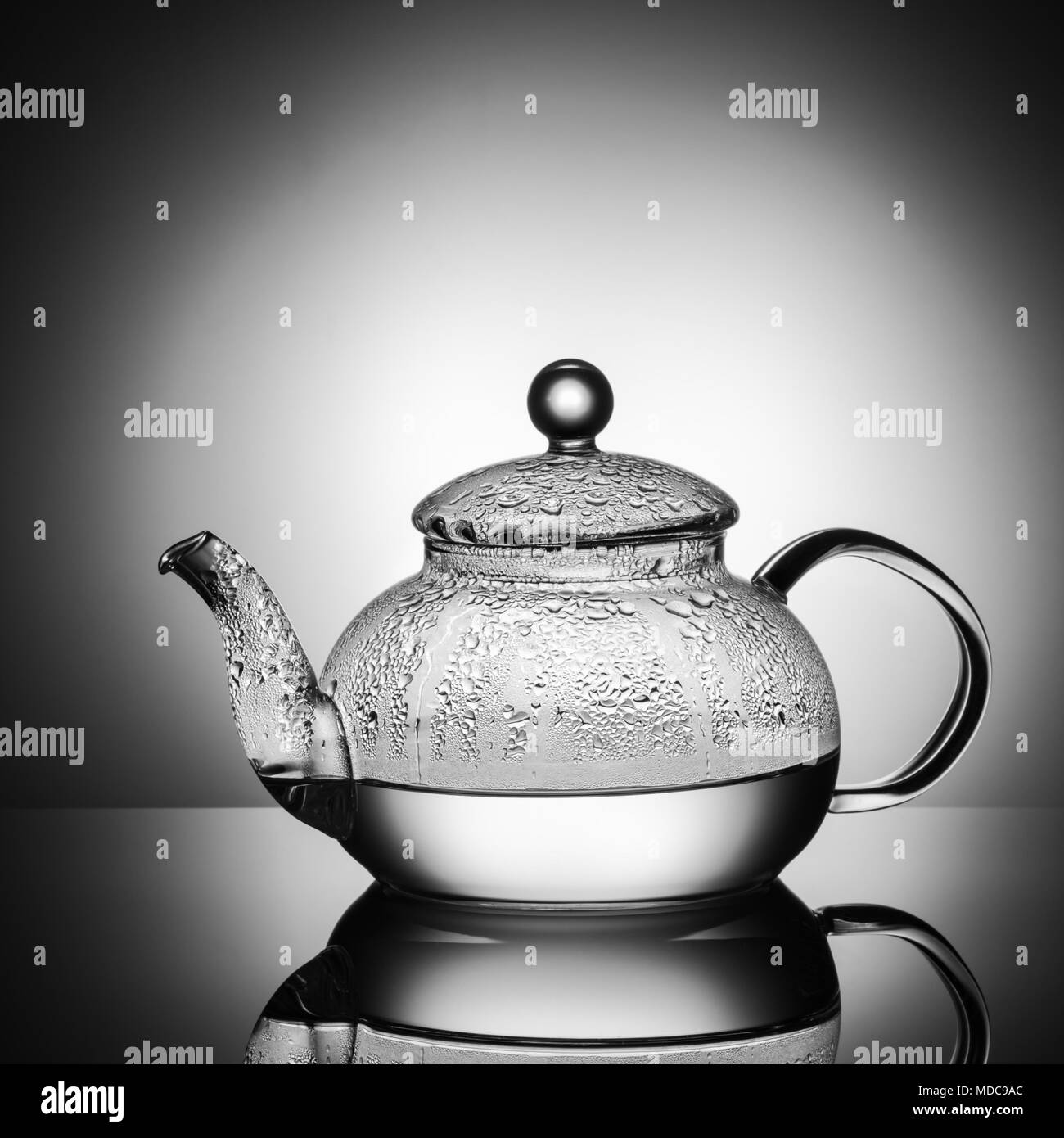 https://c8.alamy.com/comp/MDC9AC/glass-teapot-with-boiling-water-and-drops-of-condensation-on-glass-advertising-shot-on-light-black-and-white-background-with-realistic-reflection-of-g-MDC9AC.jpg