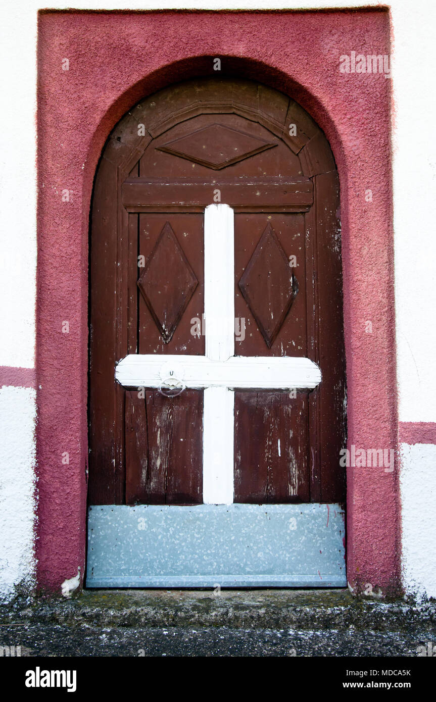wooden decorated door with white cross in the middle, entrance to small  orthodox church Stock Photo - Alamy