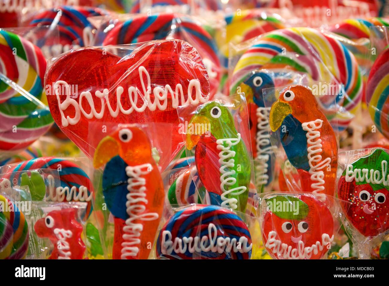 Candy lollipops shaped like hearts and parrots in the Boqeria Market in Barcelona Stock Photo