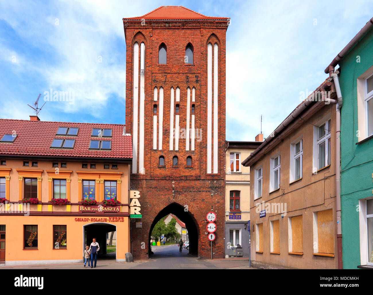 Darlowo, Western Pomerania / Poland - 2009/07/02: Historic quarter and Warsaw Insurgents street with Stone Gate known as High Gate tower Stock Photo