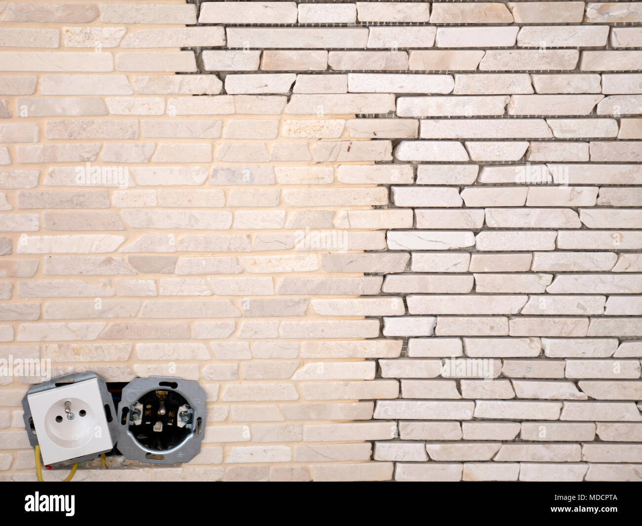 mosaic being applied on wall, electric socket installing, tile texture, background Stock Photo