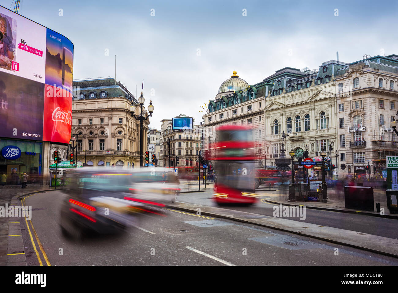 London, England - 03.15.2018: Busy traffic at Piccadilly Circus with iconic red Double-Decker bus and black taxi on the move. Piccadilly Circus is the Stock Photo