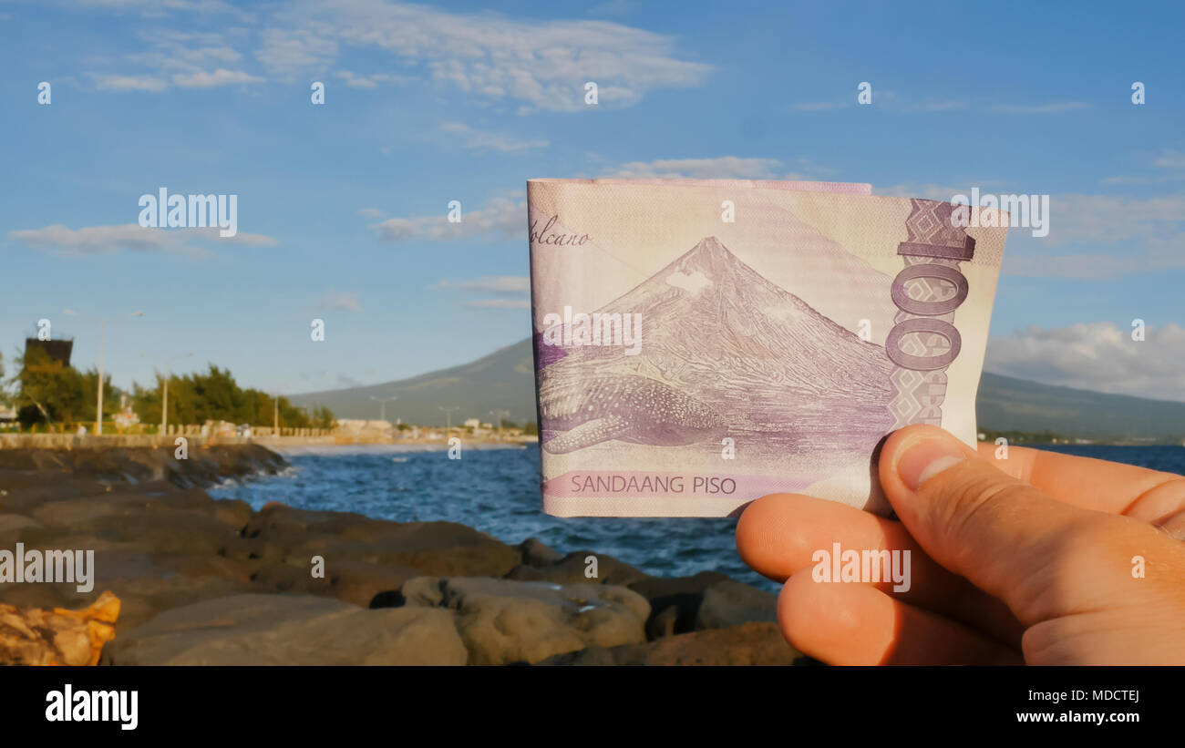 Philippine money. A Filipino monetary note in one hundred pesos is dedicated to the Mayon volcano. Stock Photo