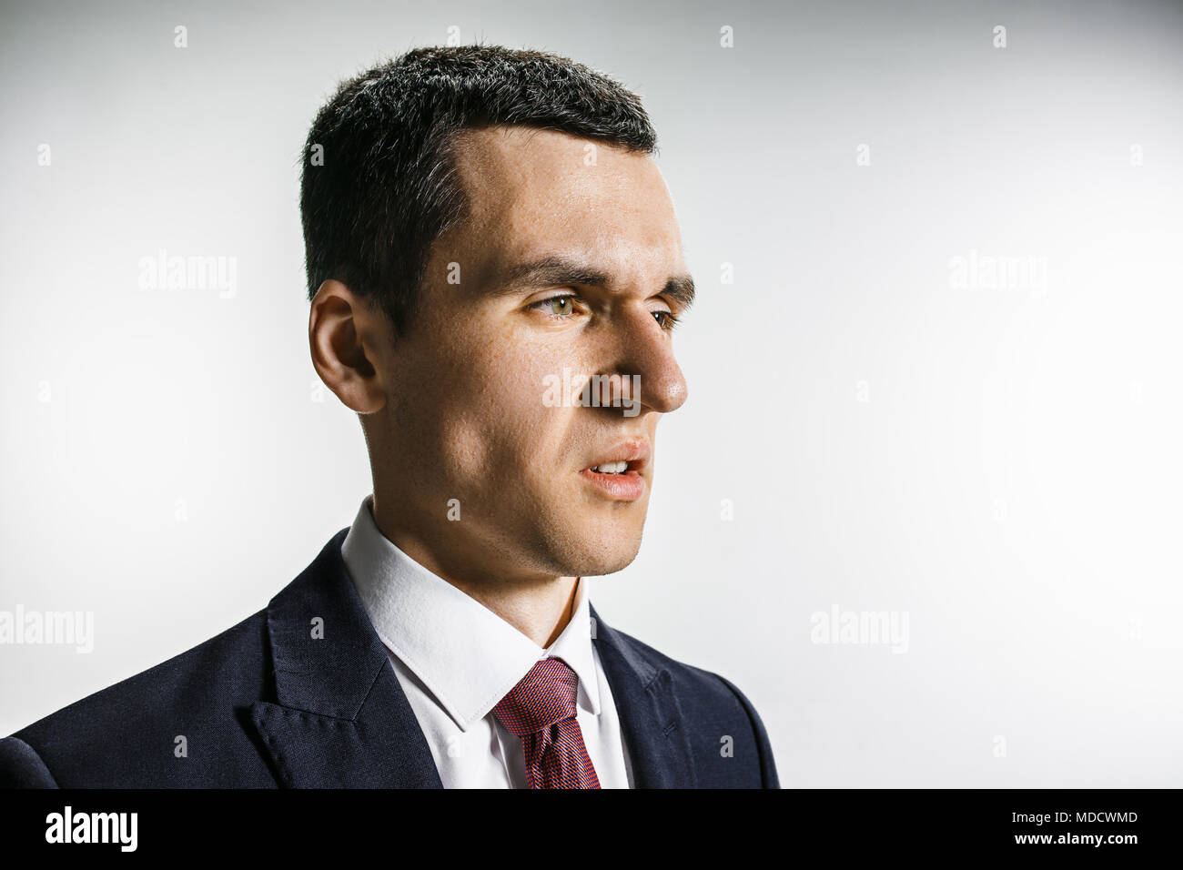 Three-quarter portrait of a businessman with disgust face. Confident professional with piercing look in the foreground of the camera. Stock Photo