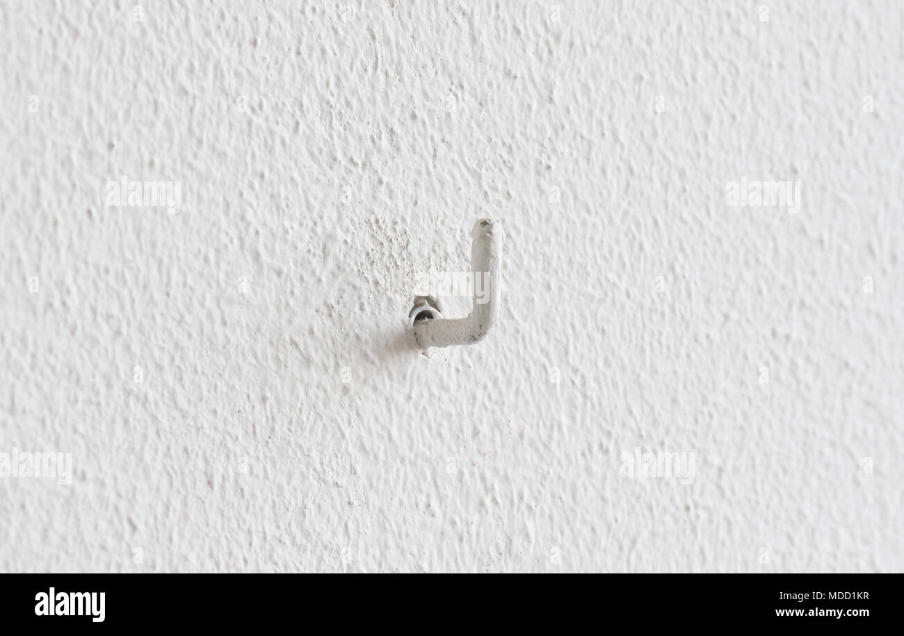 Painted small hook hanging in a wall Stock Photo Alamy