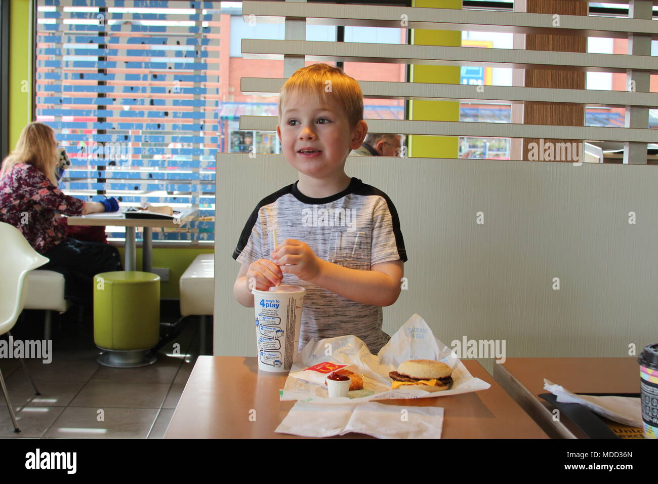 A small boy having breakfast at Mc Donald's in Llandudno Stock Photo