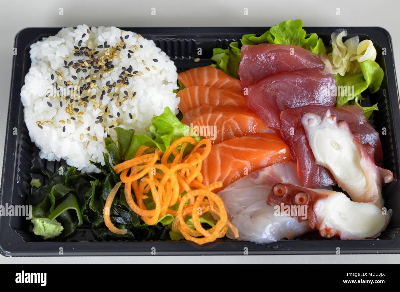 Sashimi with bluefin tuna, salmon, amberjack, octopus. As a vegetable