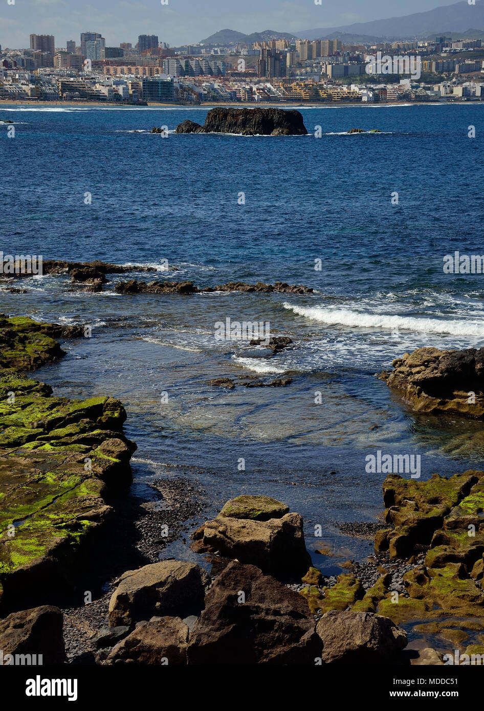 Coast at low tide in foreground and city in background, The confital and Las  palmas of Gran canaria Stock Photo - Alamy